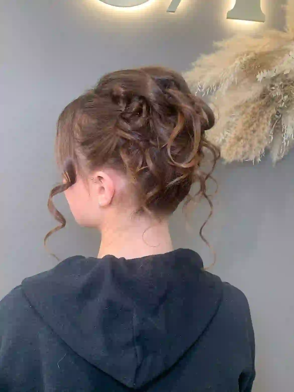 Occasion hair up with curled tendrils